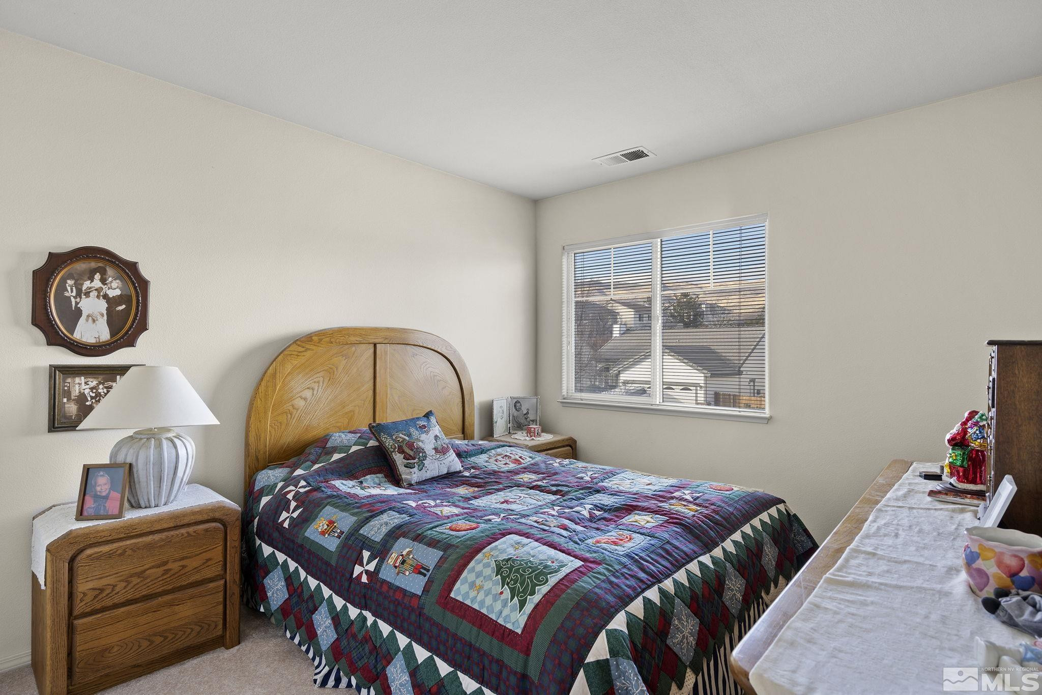 5364 Tappan Court Reno, NV 89523 - Photo 25 of 40 a bedroom with a bed a clock on the wall and a window
