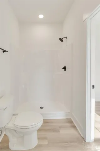 a bathroom with a toilet and a shower