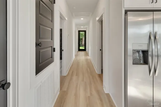 a view of a hallway with wooden floor