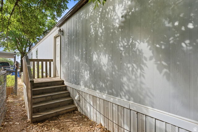 2875 North Hill Field Road, Unit 62 Layton, UT 84041 - Photo 6 of 34 White board-and-batten style siding with a contrasting skirting