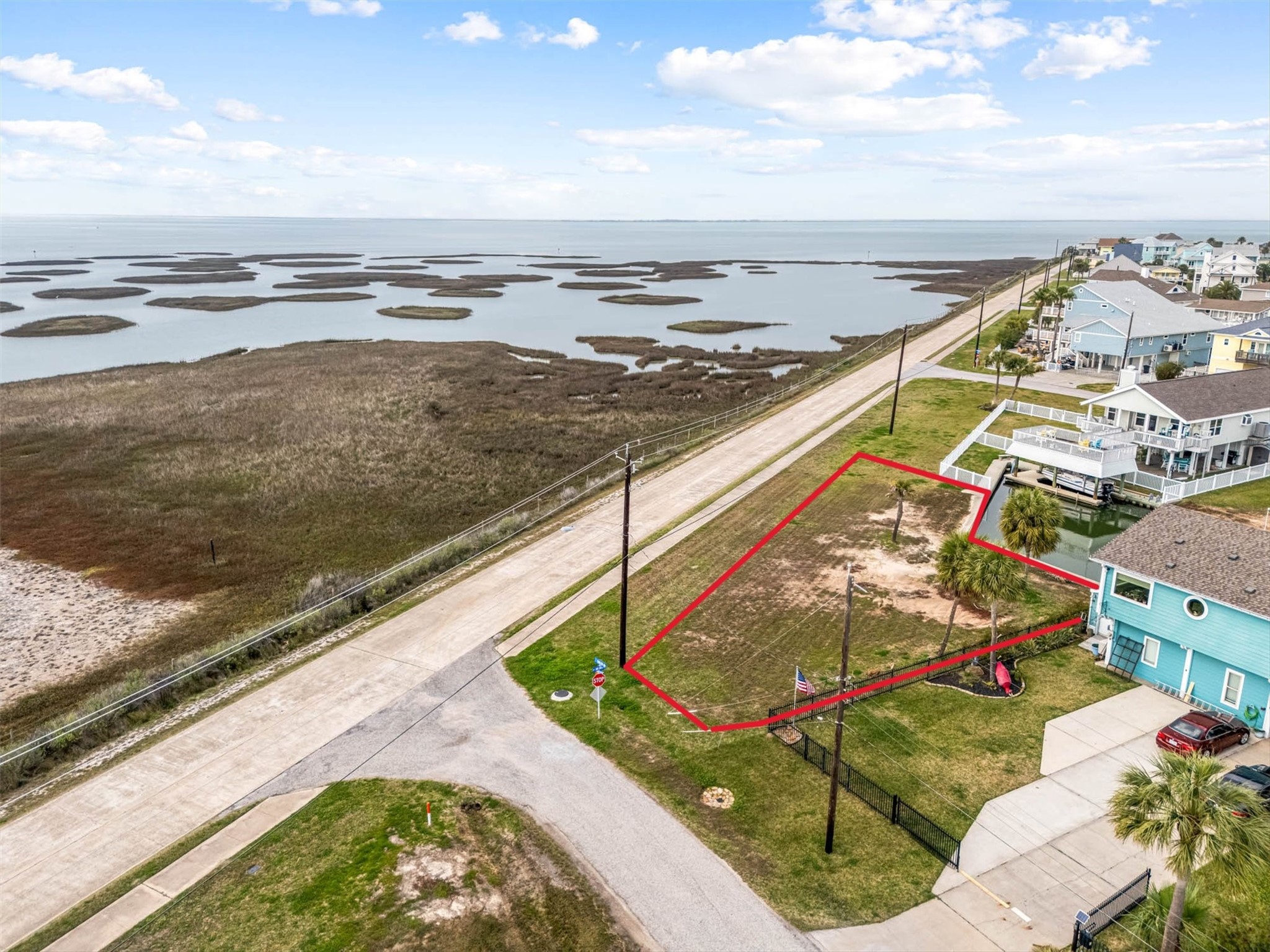 16714 Curlew Road Jamaica Beach, TX 77554 - Photo 9 of 13 a view of a lake with a building in the background