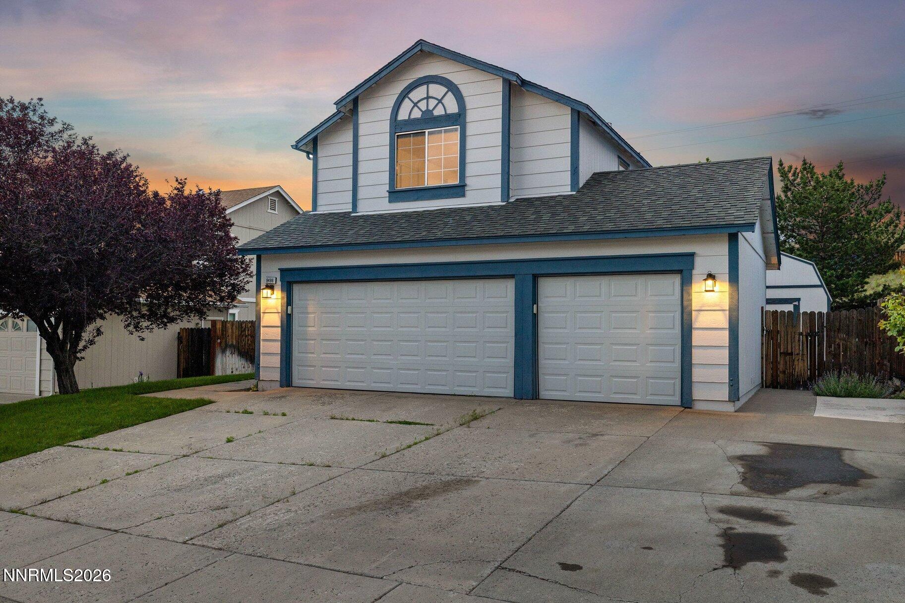8486 Piper Place Reno, NV 89506 - Photo 60 of 80 a front view of a house with a yard and garage