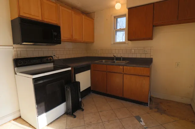 a kitchen with a sink stove and microwave
