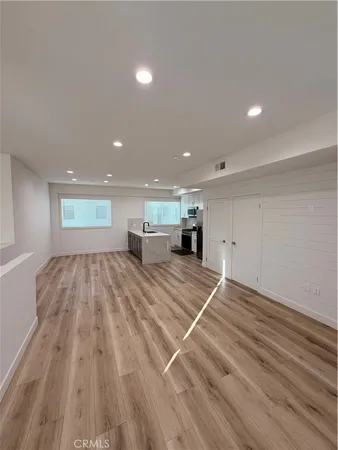 a view of a room with wooden floor and staircase