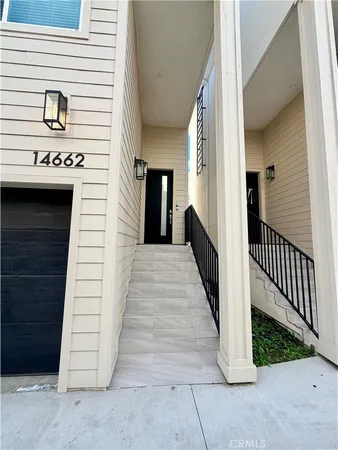 a view of a house with wooden fence and a porch