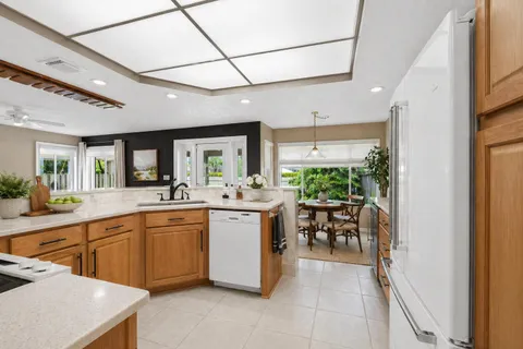 a view of a kitchen with furniture and an empty room