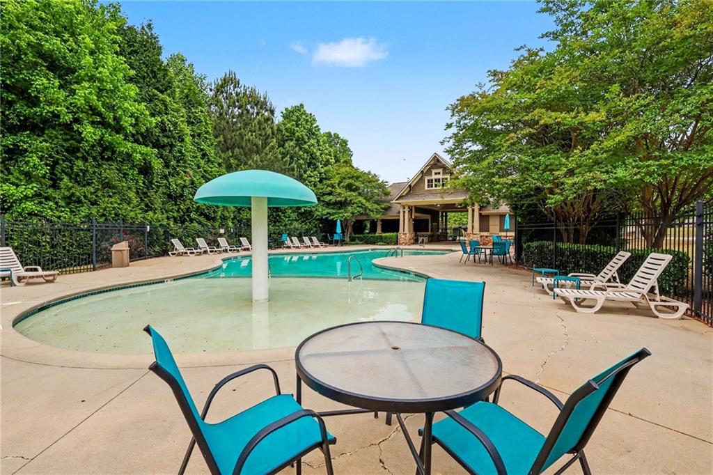 2780 Lakeview Walk Decatur, GA 30035 - Photo 31 of 37 a view of a swimming pool with a table and chairs under an umbrella