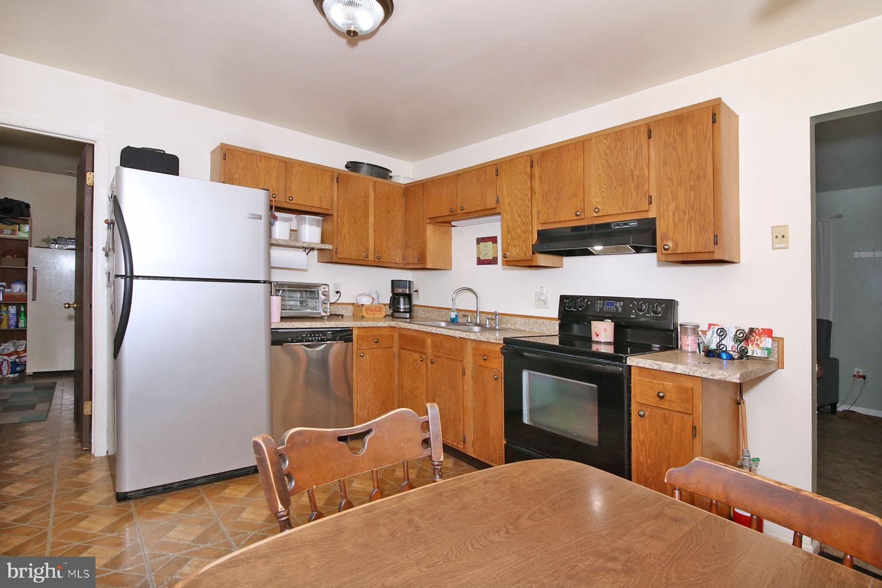 25 Walnut Mill Lane Cleona, PA 17042 - Photo 6 of 17 a kitchen with a refrigerator a stove top oven a sink and cabinets