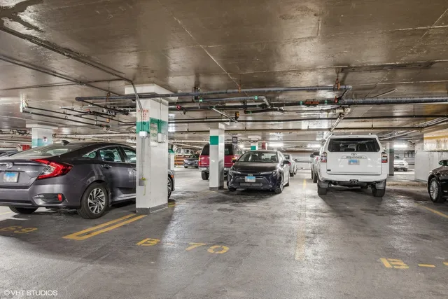 a view of parking garage with cars and