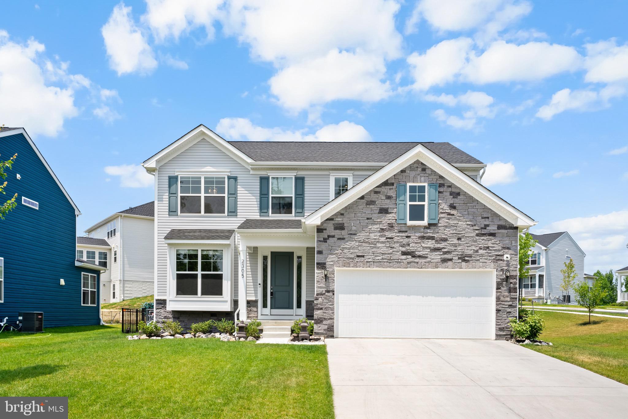 a front view of a house with a garden and yard
