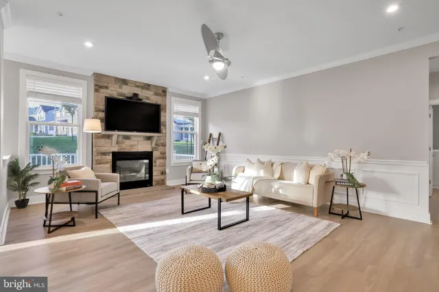 a living room with furniture and kitchen view