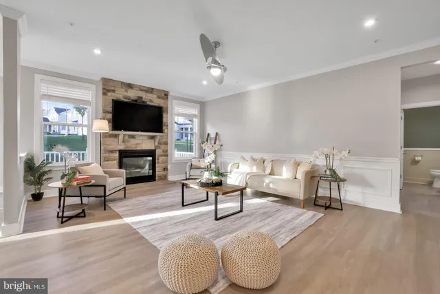 a view of a dining room with furniture large windows and wooden floor