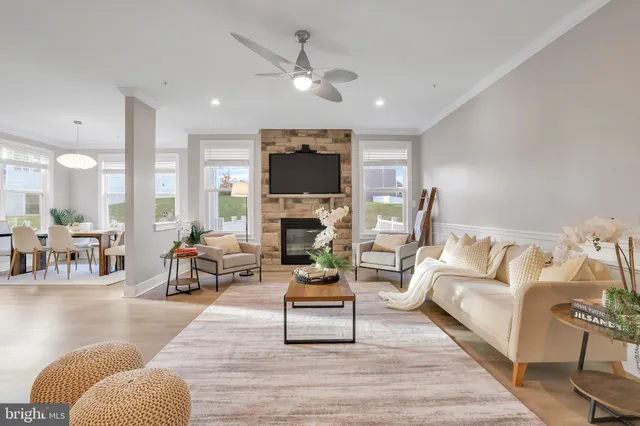 a view of a dining room with furniture large windows and wooden floor
