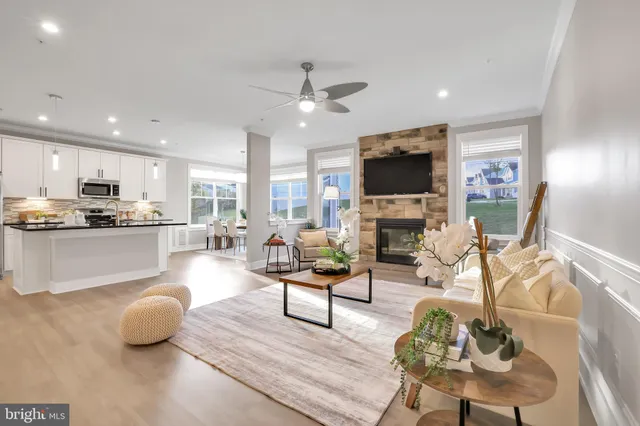 a view of a dining room with furniture a kitchen and chandelier