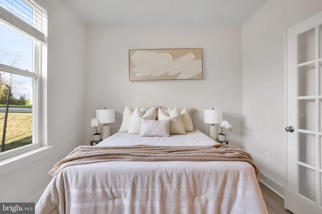 a bedroom with bed and window