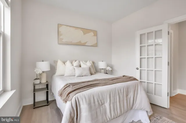 a bedroom with a bed and a ceiling fan