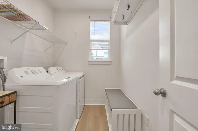 a bathroom with a granite countertop double vanity sink a toilet and a mirror