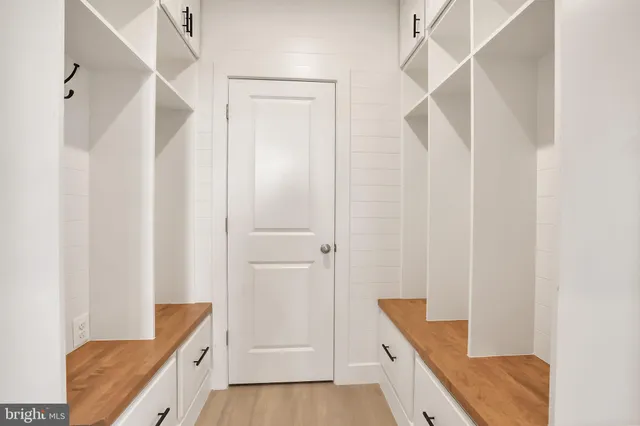 a spacious en suite bathroom with a granite countertop tub a double vanity sink and a mirror