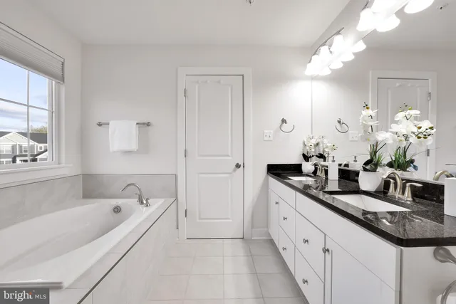 an empty room with a ceiling fan and a window