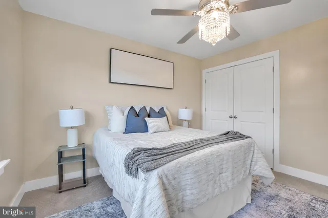 an empty room with a chandelier fan