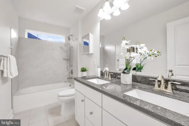 a front view of a house with a yard table and chairs
