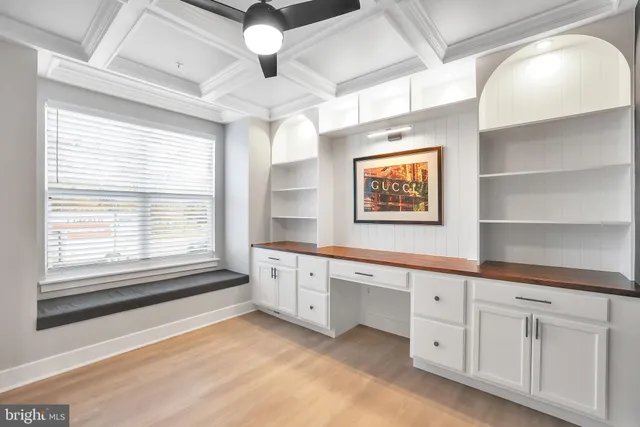 a large kitchen with stainless steel appliances lots of counter space and wooden floor