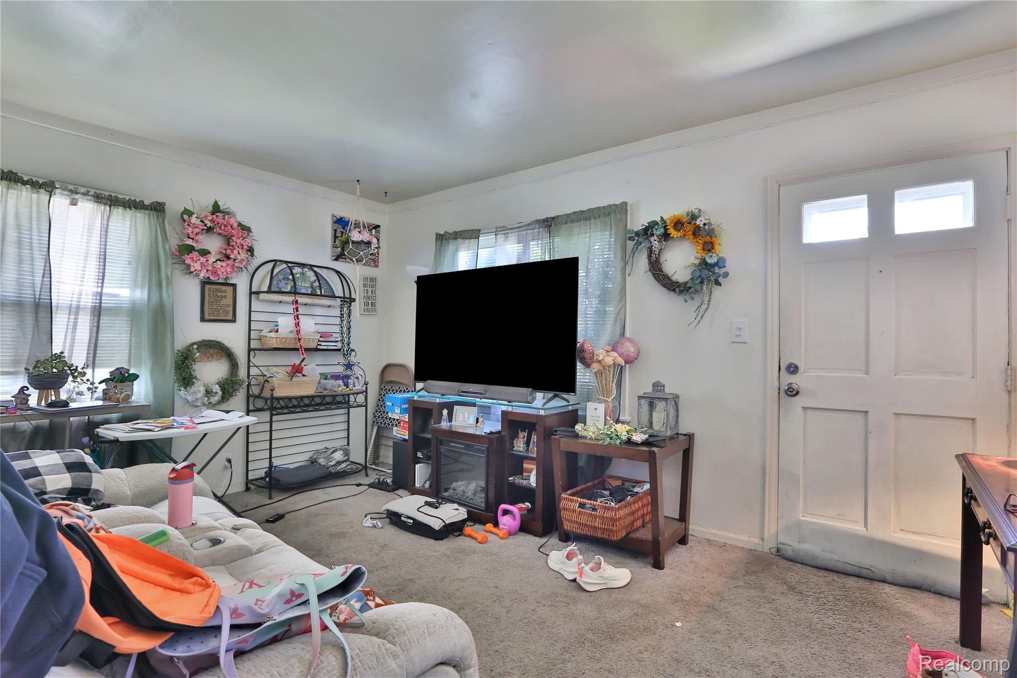 17204 Stephens Road Eastpointe, MI 48021 - Photo 5 of 11 Living area featuring carpet floors, plenty of natural light, and crown molding
