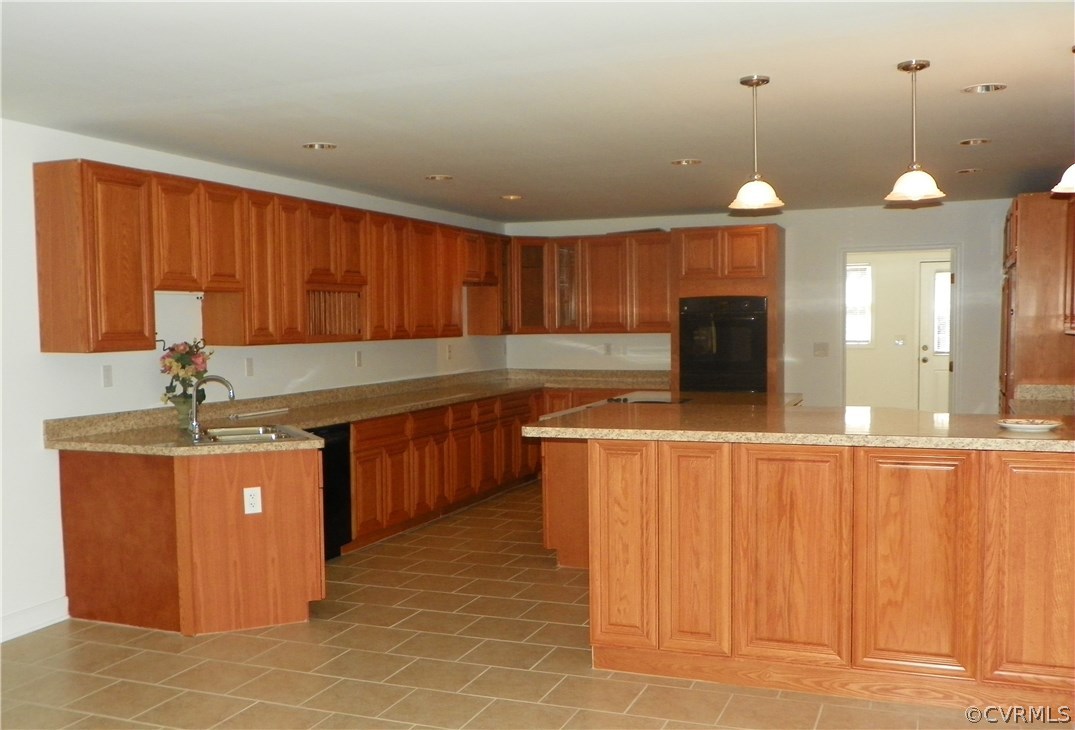 7900 Bull Hill Road Prince George, VA 23875 - Photo 5 of 24 a kitchen with stainless steel appliances granite countertop a sink and a refrigerator