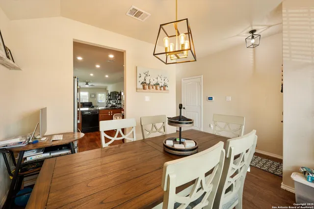 a view of a dining room with furniture and wooden floor