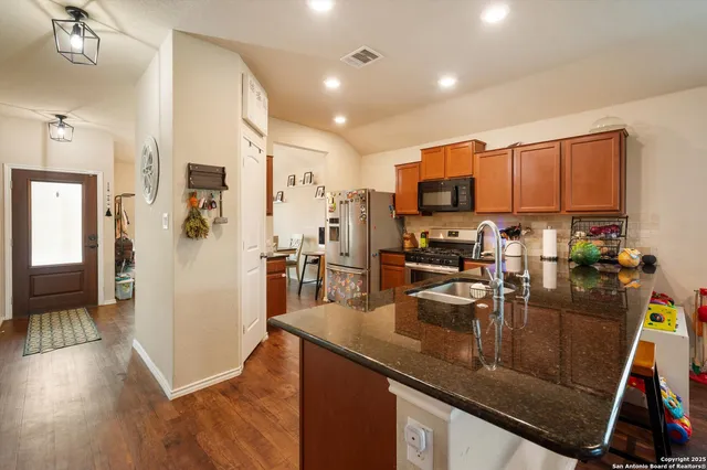 a kitchen with a sink appliances and cabinets