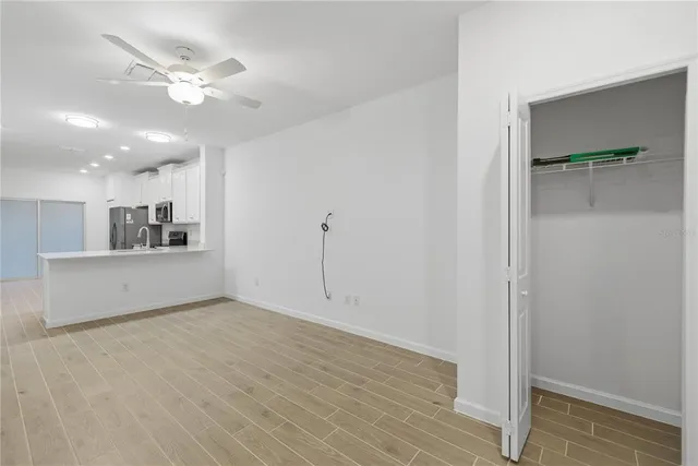 a view of an empty room with a kitchen