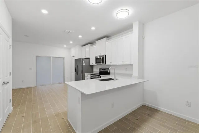 a view of kitchen with wooden floor