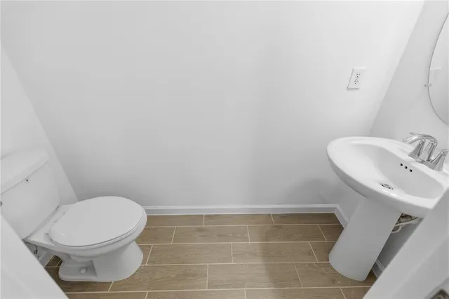 a white toilet sitting next to a white sink