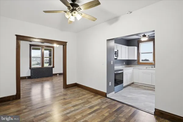 a kitchen with a refrigerator and a stove top oven