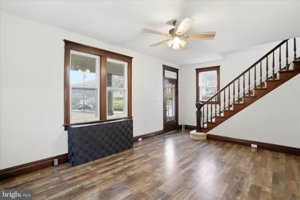 a view of an entryway with wooden floor and front door