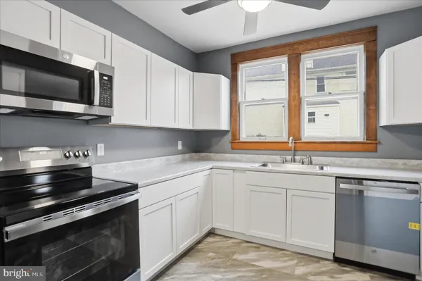a kitchen with stainless steel appliances granite countertop a sink and a stove