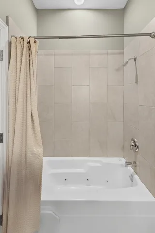 a bathroom with a shower and a tub