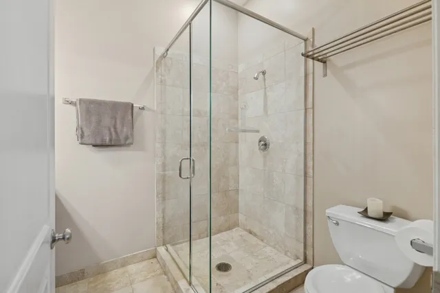 a bathroom with a shower a toilet and a sink