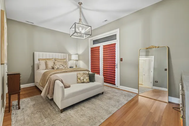 a bedroom with a bed ceiling fan and a rug