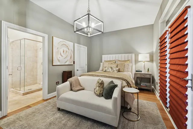 a bedroom with a bed and a chandelier