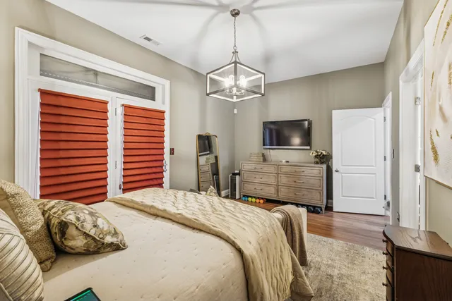 a bedroom with a bed and a television