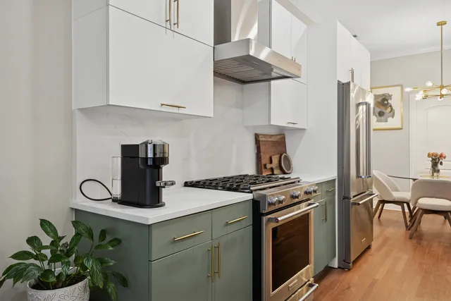a kitchen with stainless steel appliances granite countertop a stove and a wooden cabinets