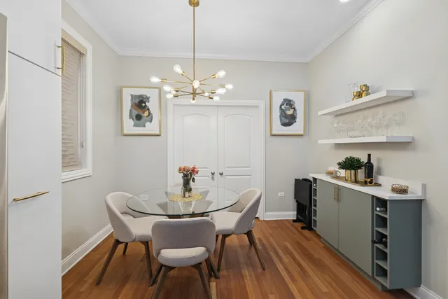 a view of a dining room with furniture wooden floor and a chandelier