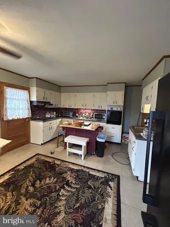 a living room with furniture stove and a table