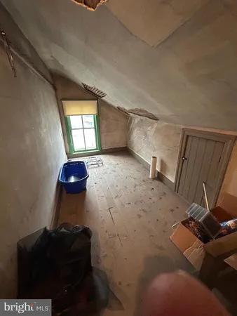 a bedroom with a large bed and a flat tv screen on dresser