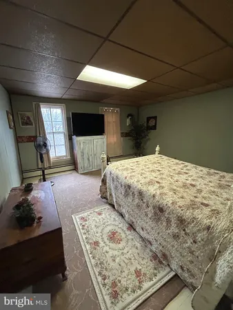 a bedroom with a bed and a night stand