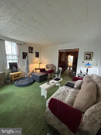 a living room with furniture a pool table and a fireplace