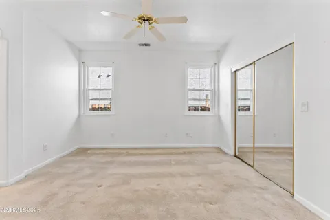 an empty room with windows and closet