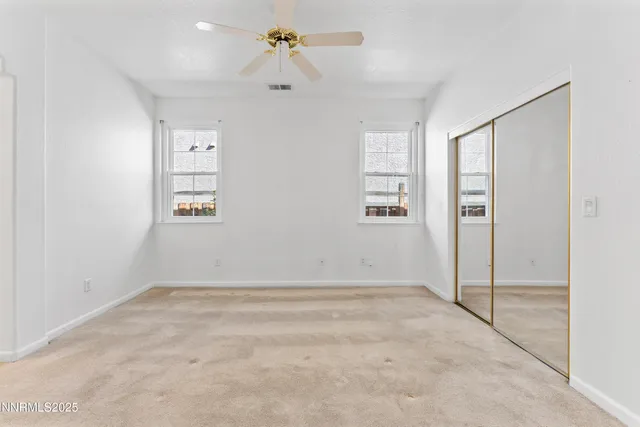 an empty room with windows and closet