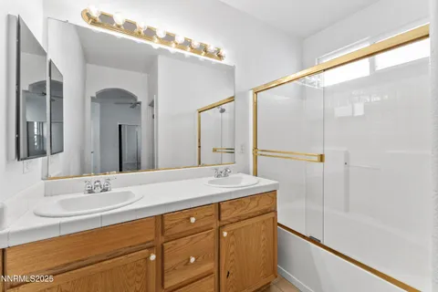 a bathroom with a sink double vanity and a mirror